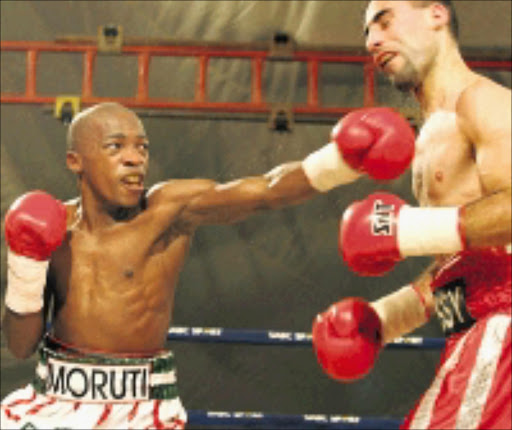 WHAM: Moruti 'Pretty Boy' Mthalane, left, lands a punch to the chin on Hussein Hussein during their fight in East London . Pic. Antonio Muchave. 05/07/08. © Sowetan.