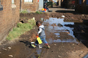 A toddler makes his way past raw sewage at the Wattville hostel in Benoni, Ekurhuleni on  June 28, 2018. The hostel has raw sewage overflowing into the walkways and hasn't seen basic service delivery in weeks. 