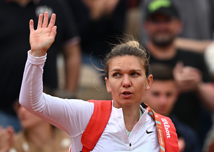 Romania's Simona Halep acknowledges the spectators after losing her second round match against China's Qinwen Zheng.