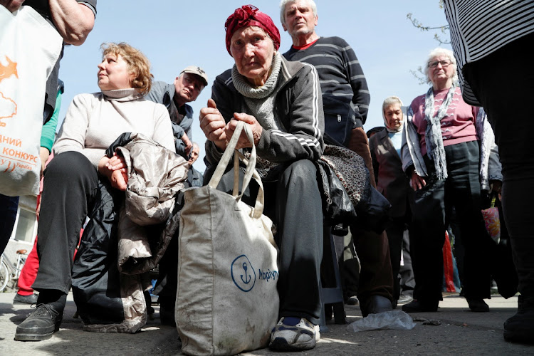 Ukrainians queue to register for social payments in the port city of Mariupol on April 26 2022.