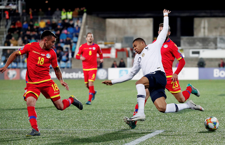 rance's Kylian Mbappe in action with Andorra's Jesus Rubio and Jordi Rubio