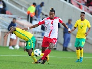 Siphesihle Ndlovu of Bafana Bafana (L) tussles for the ball with Andriamirado Hasina of Madagascar during the Cosafa Cup quarterfinal match between South Africa and Madagascar at New Peter Mokaba Stadium on June 03, 2018 in Polokwane, South Africa. Hasina is strongly linked to Kaizer Chiefs. 