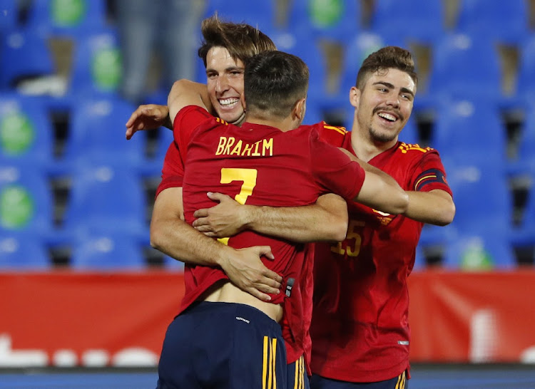 Spain's Juan Miranda celebrates scoring their third goal with Brahim Diaz and Alejandro Pozo