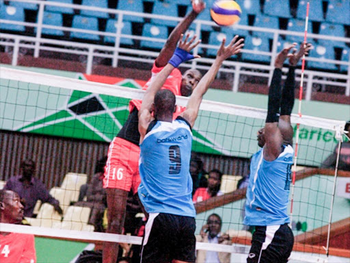 Kenya Men Volleyballer Micheal Chemos spike past Botswana Pastor Rebabonye and Kabo Moetse in FIBV Africa Men Qualifiers at Kasarani/COURTESY