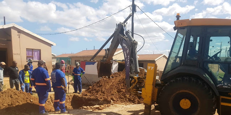 WORK IN PROGRESS: Municipal workers start repairing the broken sewage pipe