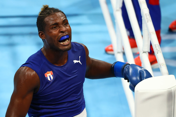 Team Cuba's Julio La Cruz celebrates defeating Muslim Gadzhimagomedov of Team ROC during the men's heavyweight final bout of the Tokyo 2020 Olympic Games