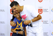 Portugal and Juventus superstar Cristiano Ronaldo speaks to a student during a visit to Yumin Primary School in Singapore on July 4, 2019. 