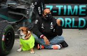 Mercedes' Lewis Hamilton poses with his dog as he celebrates after winning the Turkish Grand Prix race and the world championship at Instanbul Park. 