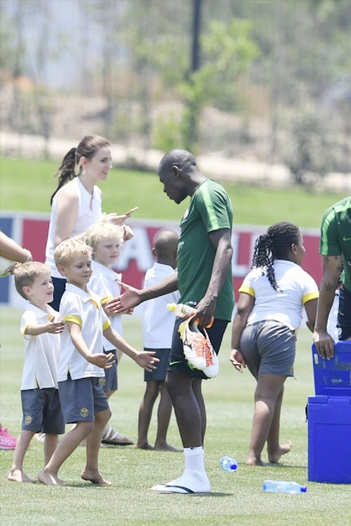 Hlompho Kekana and Bafana Bafana players meet Steyn City School kids during the team's training session.