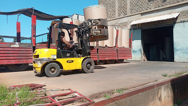 A forklift loads a reels of paper onto the truck at the Webuye Pan Paper mills