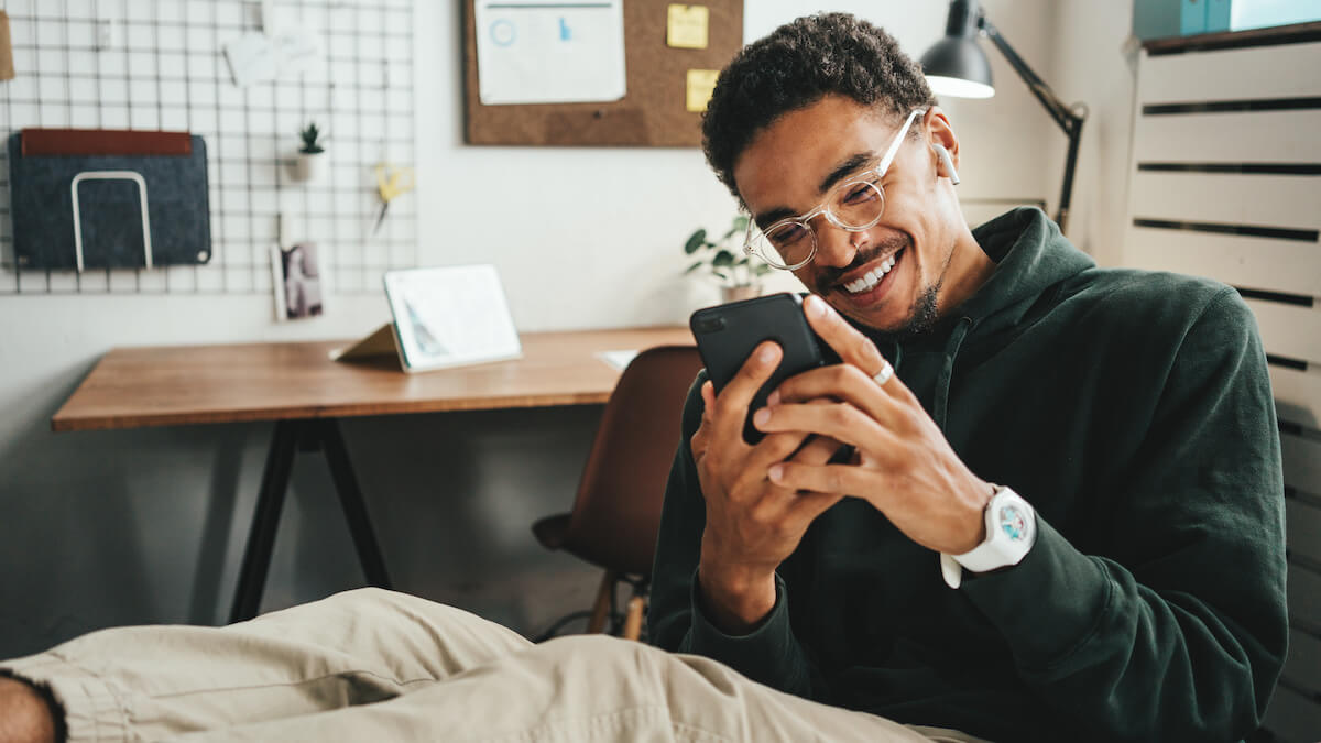 Improve patient engagement: man happily using his phone