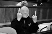 UNFAZED: Fabian Damons, one of the FNB R46 million bank robbery convicts, gestures to the camera at the Johannesburg High Court. Pic: Vathiswa Ruselo. 24/06/2009. © Sowetan