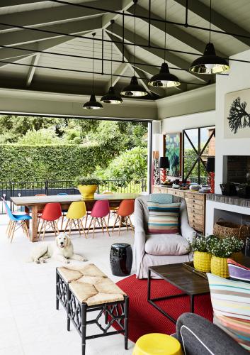 This boldly colourful, extensive veranda really is an ‘outdoor room’: it includes both dining and lounging areas, and has glass folding doors on two sides.