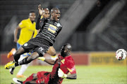 HARD TO STOP: Lerato Lamola of Bloemfontein Celtic is tackled by Denis Onyango of Mamelodi Sundowns
      
       at the Lucas Moripe Stadium
      
       on Wednesday 
      PHOTO: Muzi Ntombela/BackpagePix