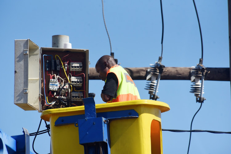 An Eskom technician fixes an electricity box in Orange Farm. Picture: FREDDY MAVUNDA