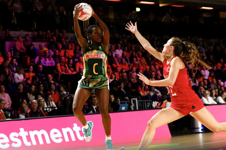 Khanyisa Chawane of South Africa competes for a ball against England