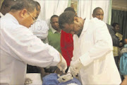 HANDS ON: Dr AHMAD tERMUZI AND KWAZULU-NATAL MEC FOR HEALTH DR SIBONGISENI DHLOMO CIRCUMCISE A PATIENT AT the BENEDICTINE HOSPITAL. Pic: THEMBA MNGOMEZULU. 11/04/2010. © Unknown