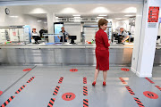 First Minister of Scotland Nicola Sturgeon stands in the canteen with social distancing markers on the floor as she visits West Calder High School amid the coronavirus disease (Covid-19) outbreak, in West Calder, Scotland. File photo 