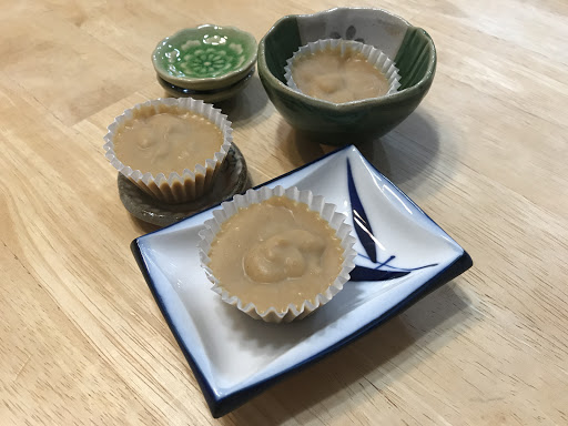 3 mini hazelnut & cocoa butter cups on small ceramic dishes.