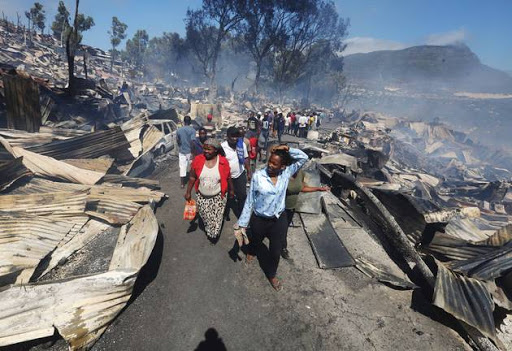 Residents walking through the destroyed mountainside township of Mandela Park in Imizamo Yethu, Hout Bay. File photo