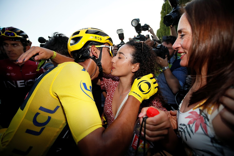 Team INEOS rider Egan Bernal of Colombia, wearing the overall leader's yellow jersey, celebrates after the finish.