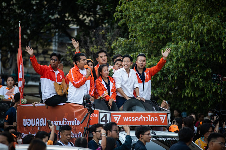 Move Forward Party leader Pita Limjaroenrat, second from right, greets supporters during a celebratory parade in Bangkok on May 15 2023 after winning the most seats in Thailand’s general election. Picture: GETTY IMAGES/Lauren Decicca