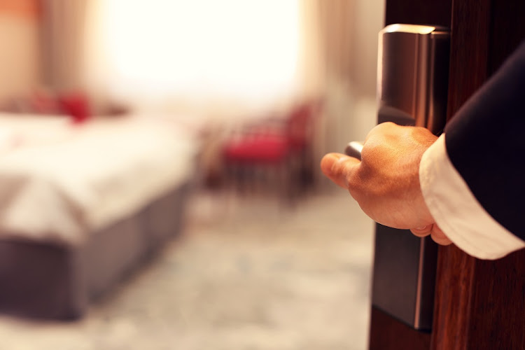 Man erects banner to scare off hotel guests.