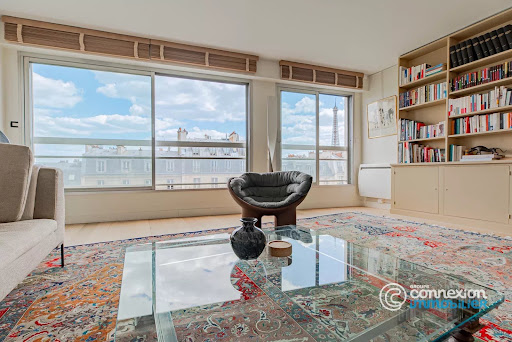 Living room with view of Paris and Eiffel Tower in this luxury property for sale in Paris 16ème ($2,012,186 - 107 m²)