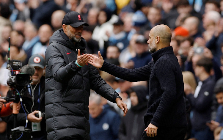 Liverpool manager Juergen Klopp shakes hands with Manchester City manager Pep Guardiola after their Premier League match at Etihad Stadium in Manchester in April 2023.