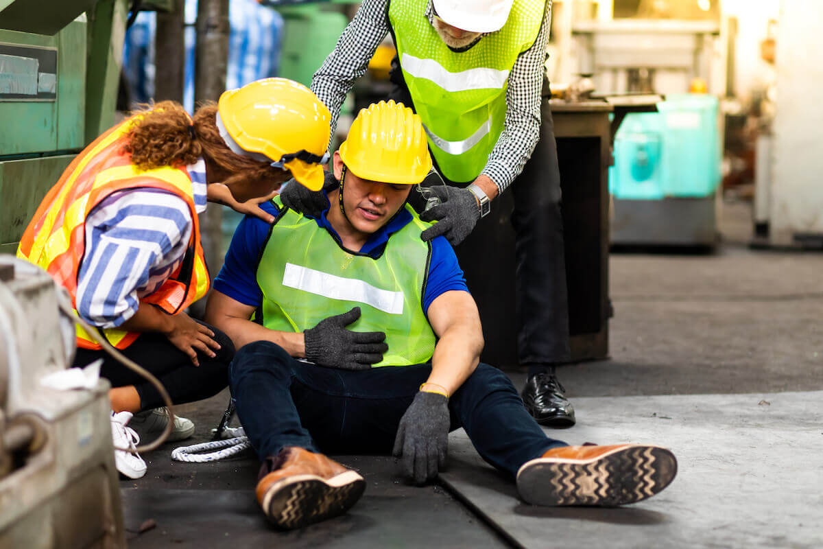 Work injury: workers assisting their colleague who's injured