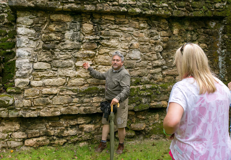 Tour guide Hugo shows a small group of visitors the Mayan ruins of Dzibanche dating to the third century A.D. 