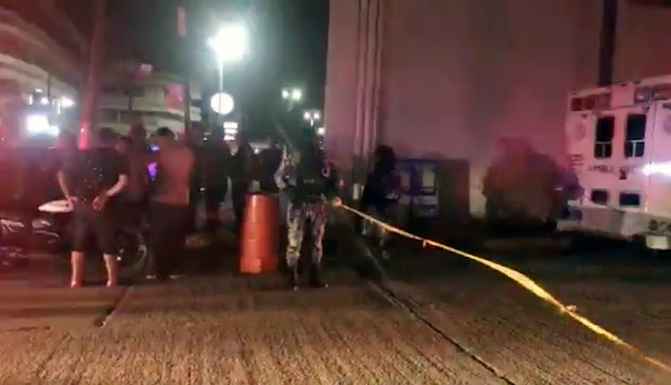 People gather at the scene of an arson attack, as they wait for news, in Coatzacoalcos, Mexico, August 27, 2019 in this still image obtained from social media video by Reuters on August 28 2019.