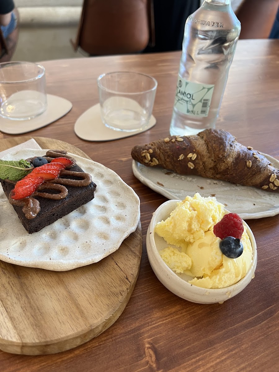 Brownie served with vanilla ice cream and a croissant