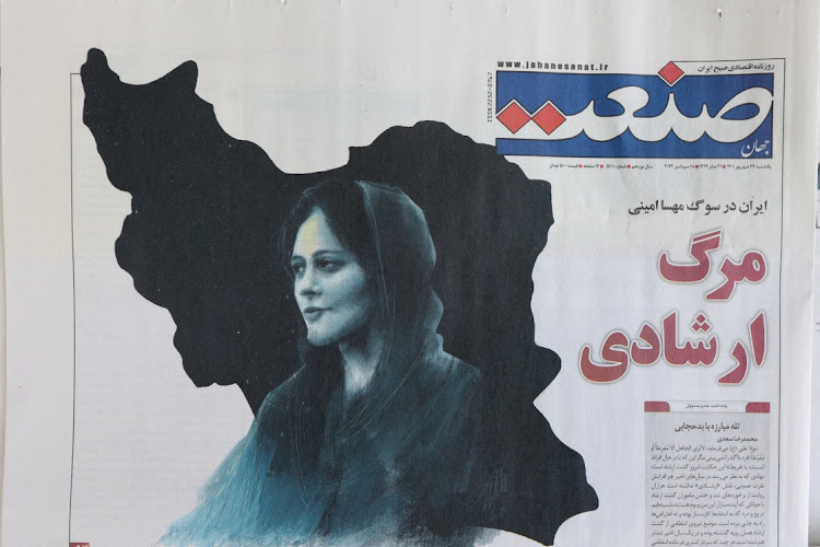 A newspaper with a cover picture of Mahsa Amini, a woman who died after being arrested by the Islamic republic's "morality police" is seen in Tehran, Iran on September 18, 2022. Picture: Majid Asgaripour/WANA via REUTERS