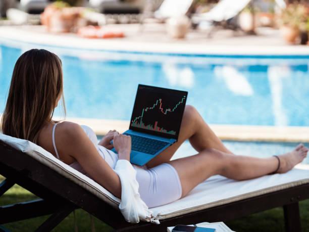 Beautiful Young Woman Trading On Stock Market Using Laptop Computer Outdoors In Summer Season Beautiful Young Woman Trading On Stock Market Using Laptop Computer Outdoors In Summer Season forex trading account stock pictures, royalty-free photos & images