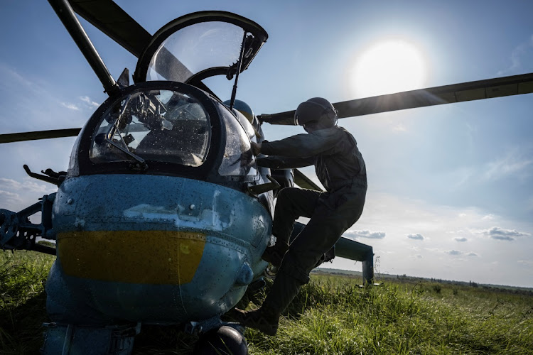 A Ukrainian pilot prepares to take off to carry out a mission in a Mi-24 attack helicopter amid Russia's attack on Ukraine. Picture: VIACHESLAV RATYNSKYI/REUTERS.