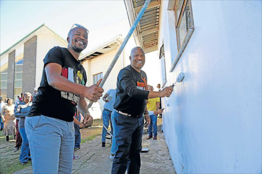 GOING FOR IT: Ayanda Jam, left, with ANC provincial secretary Oscar Mabuyane, painting walls at Ethembeni Old-Age home in NU1 Mdantsane yesterday Picture: MARK ANDREWS