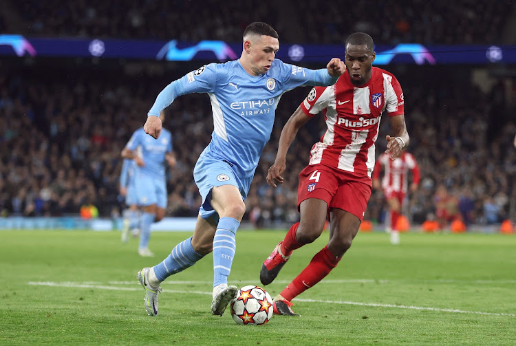 Manchester City's Phil Foden in action with Atletico Madrid's Geoffrey Kondogbia