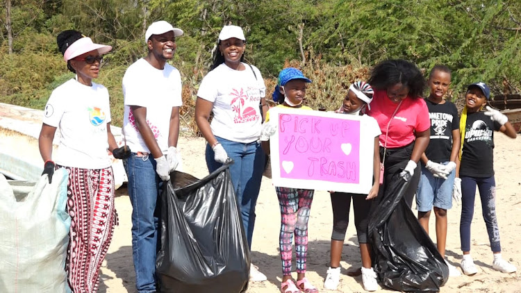 Nesha Omar (C) with her friends and members of Progress Welfare Association of Malindi during the launch of her pick your trash campaign in Malindi