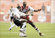 MERRY DANCE: Pirates Onyekachi Okonkwo displays neat footwork while Birds' Niang Mame blocks his path in thier Premiership match at Ellis Park Stadium on Satuday. Pic. Antonic Muchave. 21/01/2007. © Sowetan.