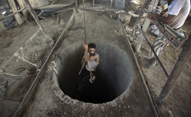 A man lowers himself into a Hamas tunnel circa 2014.