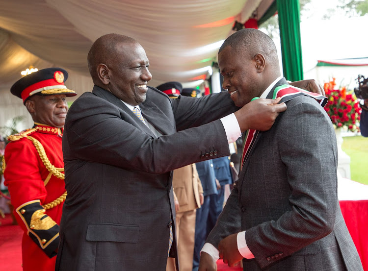 President William Ruto and Kiharu MP Ndindi Nyoro awarding him with the State commendation of the Chief of the Order of the Burning Spear (CBS) at State House on December 12, 2022