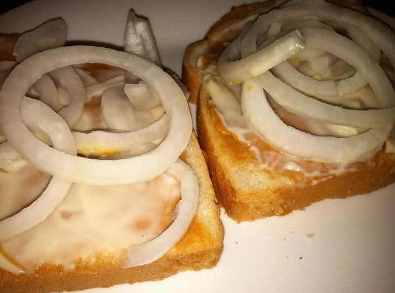 Bread With Spread Peanut Butter, Spread Mayonnaise And Sliced Onions.