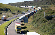 Lorries queue up on the road A20 in Kent following the road closure caused by the Insulate Britain protest at the entrance of Port of Dover, Britain, September 24, 2021. 