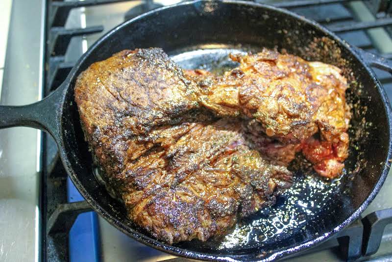 Searing Meat, Covered In Seasonings, In A Skillet.