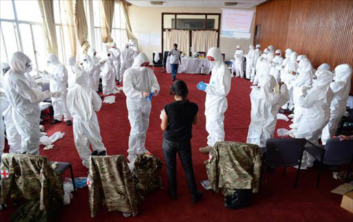 Medical personnel from 22 Field Hospital alongside members of the World Health Organisation who are training nationals in the application of Personal Protective Equipment in Freetown Football Stadium during a training course in Freetown, Sierra Leone. The World Health Organisation (WHO) is investigating reports on 2 January 2015 that ISIS militants have been showing up at an Iraqi hospital with symptoms of the Ebola virus. File photo.