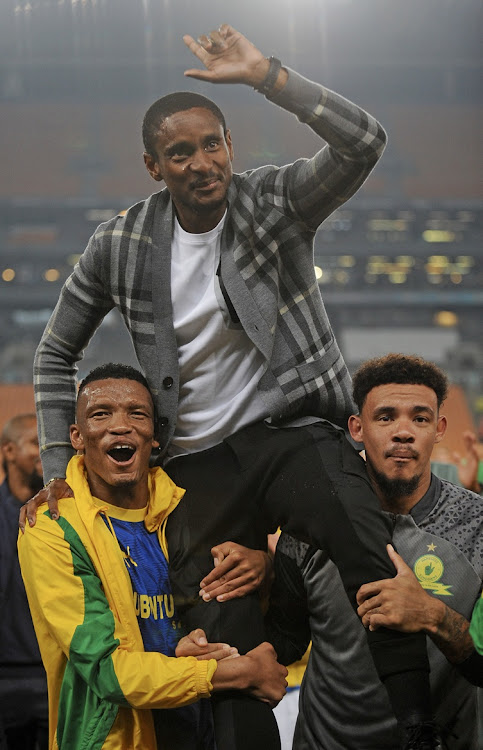 Mothobi Mvala and Ronwen Williams lift Sundowns coach Rulani Mokwena after the match.