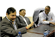 Duduzane Zuma, right, with Ajay and Atul Gupta in the offices of their newspaper, The New Age, in Midrand, Gauteng, in 2011. 