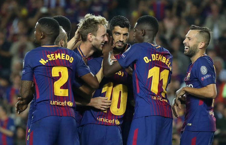 Barcelona's Ivan Rakitic celebrates scoring their second goal with team mates.