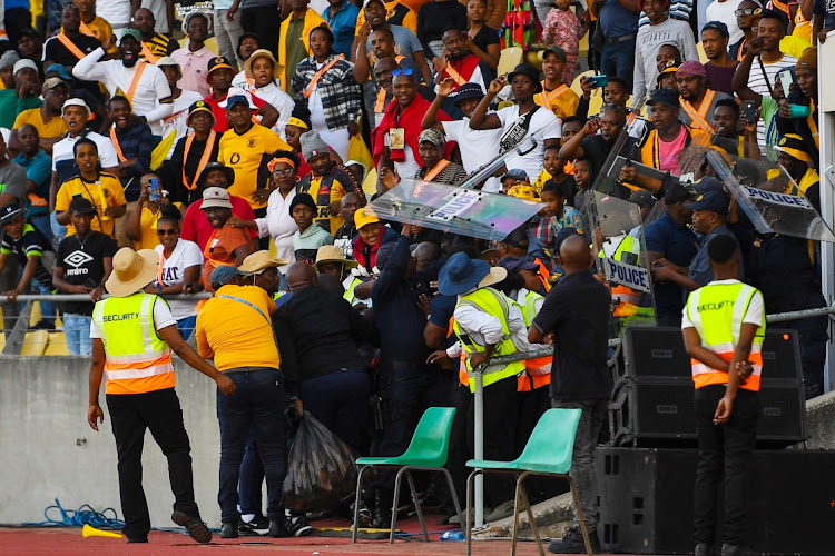 Police protect Kaizer Chiefs coach Arthur Zwane from fans during the DStv Premiership match between SuperSport United and Kaizer Chiefs at Royal Bafokeng Stadium on May 13, 2023 in Rustenburg, South Africa.